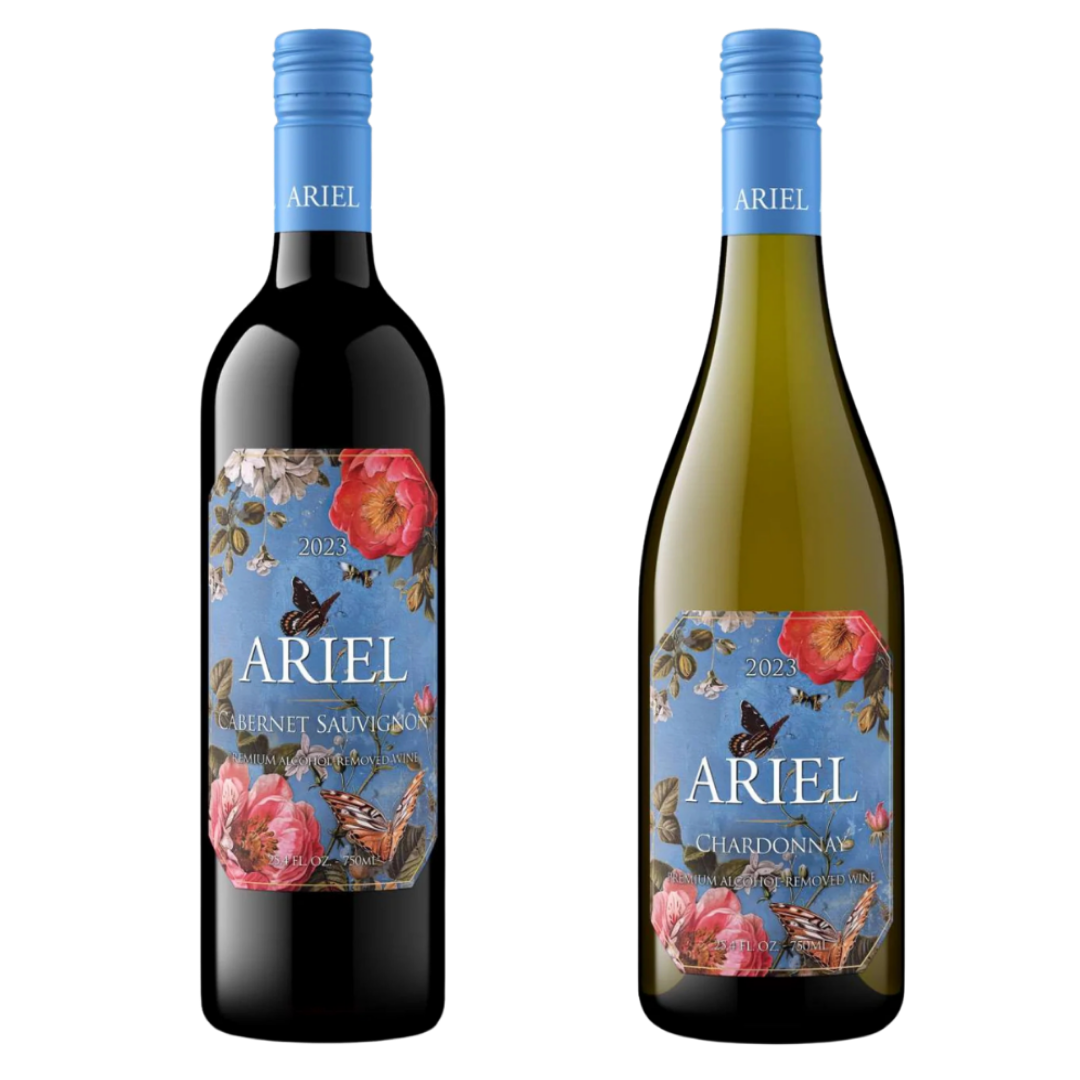 Two Ariel wine bottles on a plain white background: a dark red wine bottle labeled Cabernet Sauvignon and a pale green wine bottle labeled Chardonnay, both with blue caps and matching floral labels.