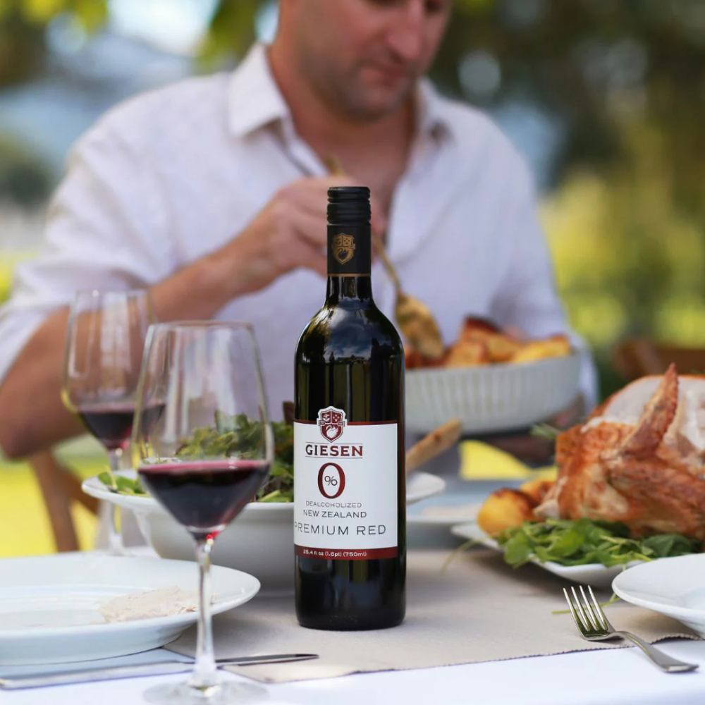 Giesen Red Blend Poured in glass with food