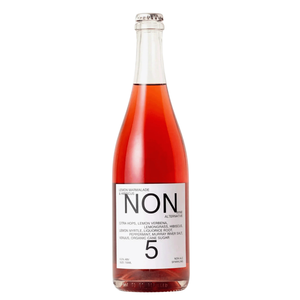 A glass bottle of Non 5 Lemon Marigold Ale, featuring a vibrant pinkish-amber liquid and a white label with black text, set against a plain white background.