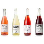 Four glass bottles of NON. Non-Alcoholic Sparkling Wine arranged in a row against a plain white background, showing different wine colors labeled 1, 3, 5, and 7.