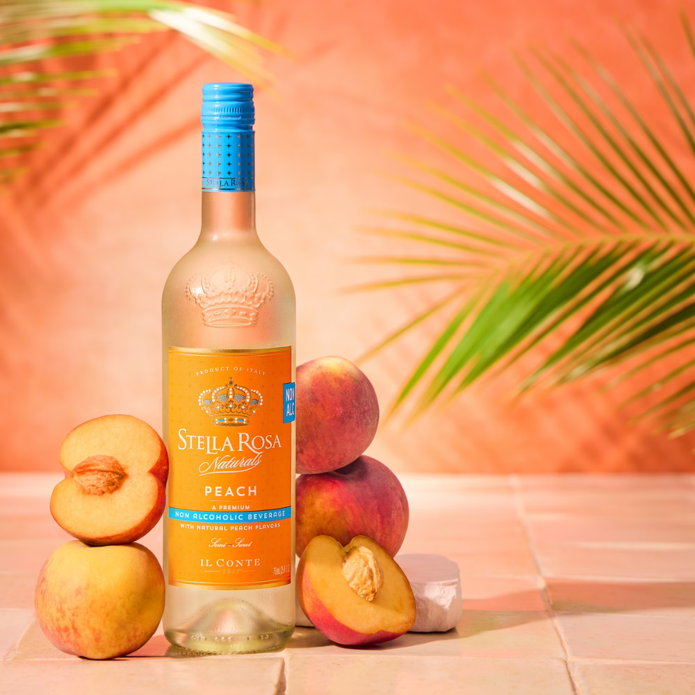Stella Rosa Peach Non Alcoholic Wine with peach fruit next to bottle